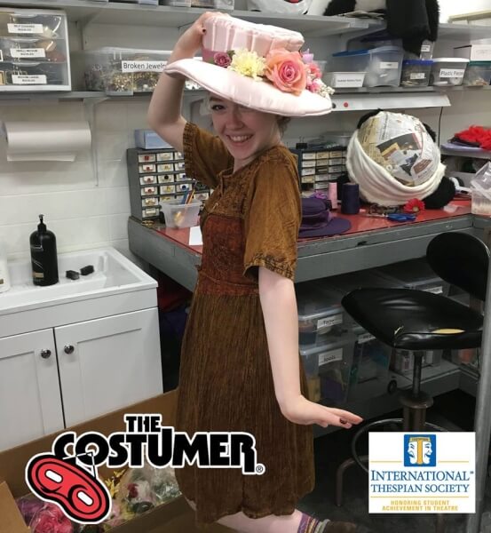 Grace White International Thespian Society Intern for The Costumer Modelling one of the many hats worn at The Costumer